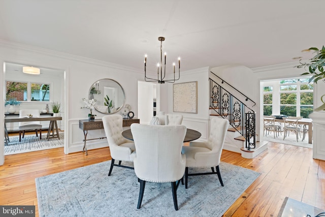 506 Ivy Cir, Alexandria, VA 22302 - dining room featuring a notable chandelier, ornamental molding, stairway, wood-type flooring, and a wainscoted wall