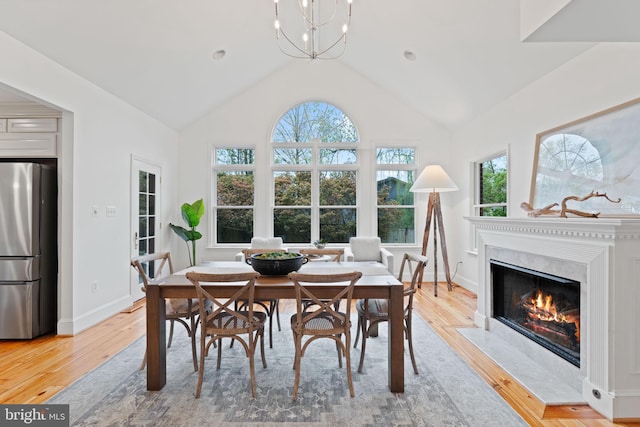 506 Ivy Cir, Alexandria, VA 22302 - dining area with a premium fireplace, light wood-style floors, high vaulted ceiling, and baseboards