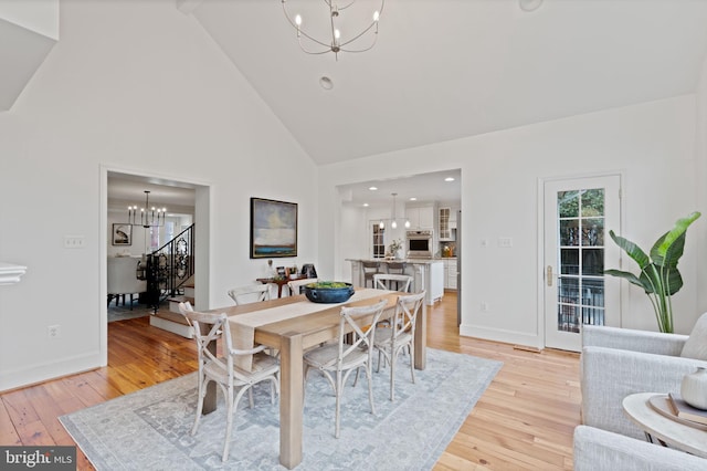 506 Ivy Cir, Alexandria, VA 22302 - dining area with high vaulted ceiling, light wood finished floors, a notable chandelier, and baseboards