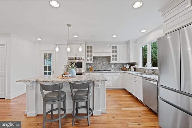 506 Ivy Cir, Alexandria, VA 22302 - kitchen with premium range hood, white cabinets, decorative backsplash, stainless steel appliances, and a sink