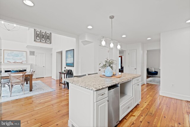 506 Ivy Cir, Alexandria, VA 22302 - kitchen with white cabinetry, light wood finished floors, recessed lighting, pendant lighting, and a kitchen island