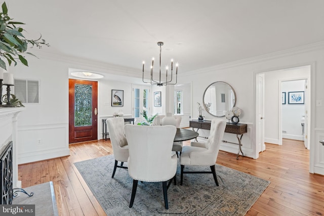 506 Ivy Cir, Alexandria, VA 22302 - dining area with crown molding, visible vents, a wainscoted wall, light wood finished floors, and a notable chandelier