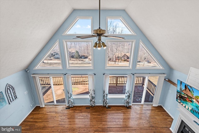 bonus room featuring high vaulted ceiling, a ceiling fan, baseboards, and wood finished floors