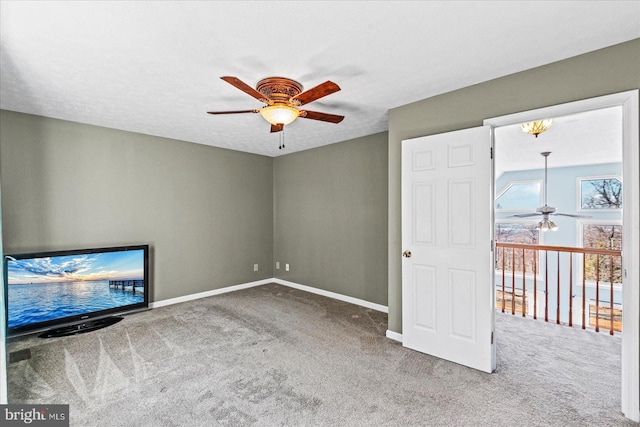 interior space with carpet flooring, a ceiling fan, and baseboards