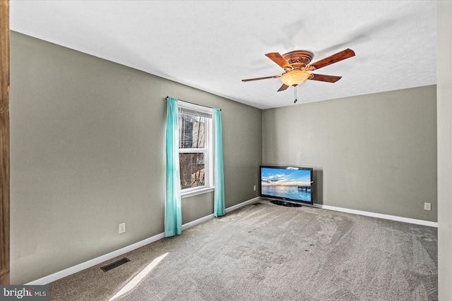 unfurnished living room with a ceiling fan, baseboards, visible vents, and carpet flooring