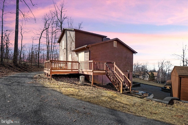 exterior space with an outbuilding and a wooden deck