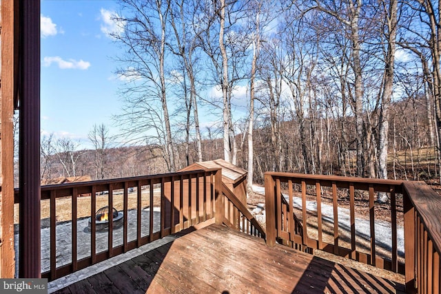 wooden deck featuring a forest view