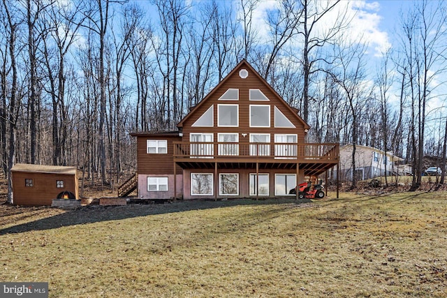 back of house with an outdoor structure, a yard, stairway, a wooden deck, and a shed