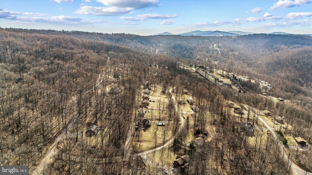 aerial view with a mountain view and a view of trees