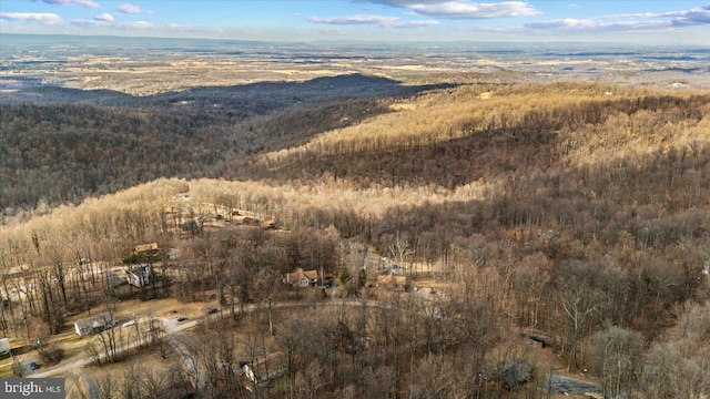 aerial view featuring a forest view and a mountain view