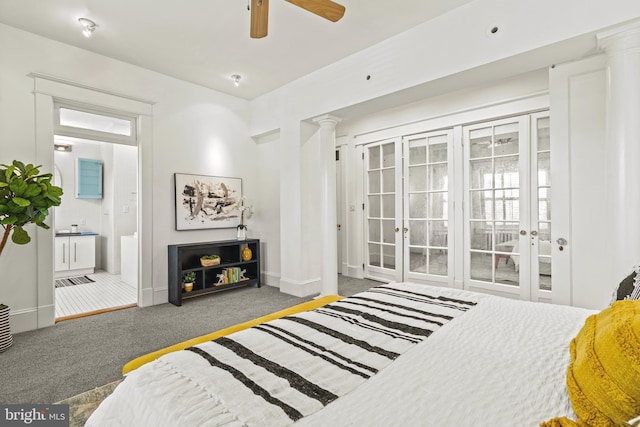 bedroom featuring baseboards, ensuite bathroom, carpet flooring, and ornate columns