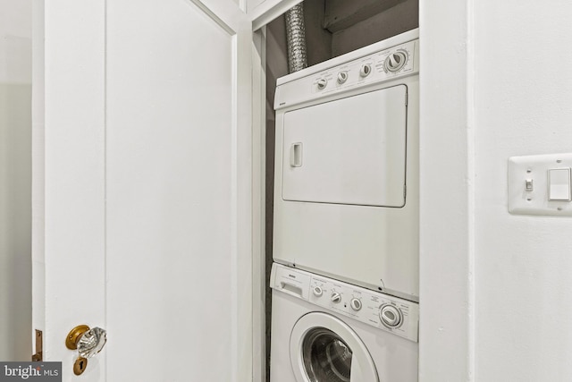 clothes washing area featuring laundry area and stacked washer and clothes dryer