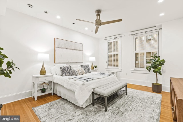 bedroom featuring a ceiling fan, recessed lighting, baseboards, and wood finished floors