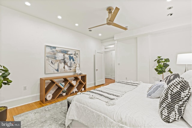 bedroom with baseboards, wood finished floors, a ceiling fan, and recessed lighting