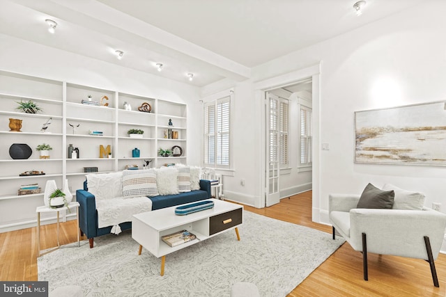 living room with baseboards and wood finished floors