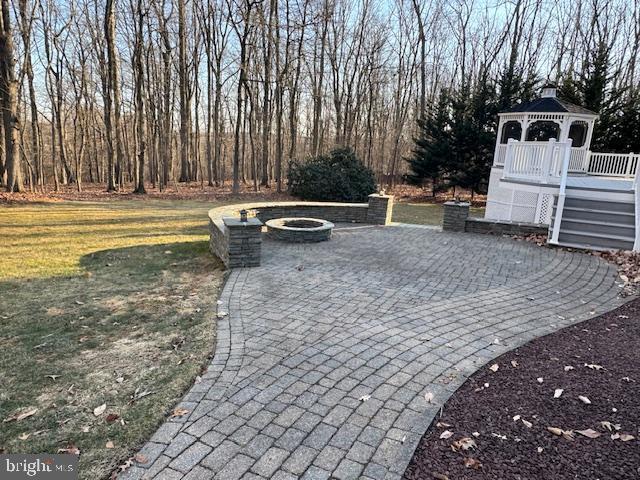 view of patio with a gazebo and an outdoor fire pit