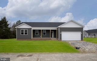 ranch-style house featuring a garage and a front yard