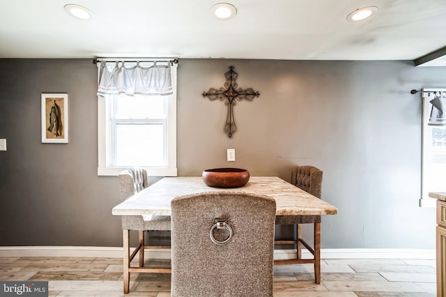 dining space with light wood-type flooring, baseboards, and recessed lighting