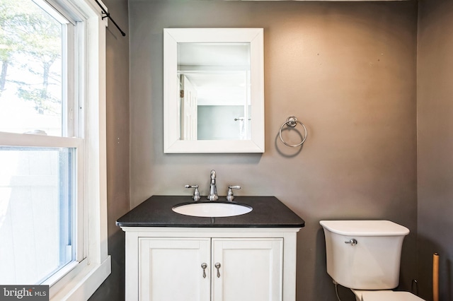 bathroom featuring toilet and vanity