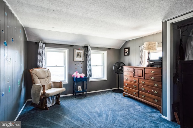 living area with vaulted ceiling, a textured ceiling, carpet flooring, and baseboards