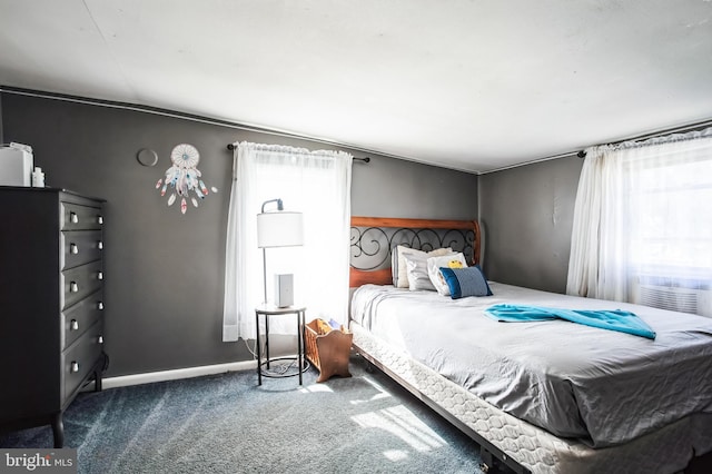 carpeted bedroom featuring baseboards