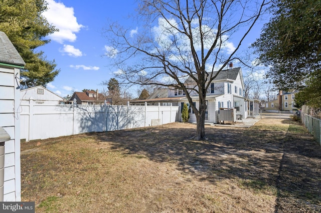 view of yard with a residential view and a fenced backyard