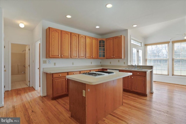 461 Apple Cross Rd, Harpers Ferry, WV 25425 - kitchen with light countertops, a sink, light wood-style floors, glass insert cabinets, and white gas cooktop