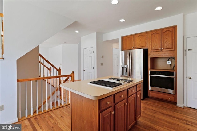 461 Apple Cross Rd, Harpers Ferry, WV 25425 - kitchen with light countertops, wood finished floors, a kitchen island, and stainless steel appliances