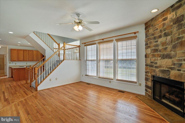 461 Apple Cross Rd, Harpers Ferry, WV 25425 - unfurnished living room with stairway, baseboards, a ceiling fan, and light wood-style floors