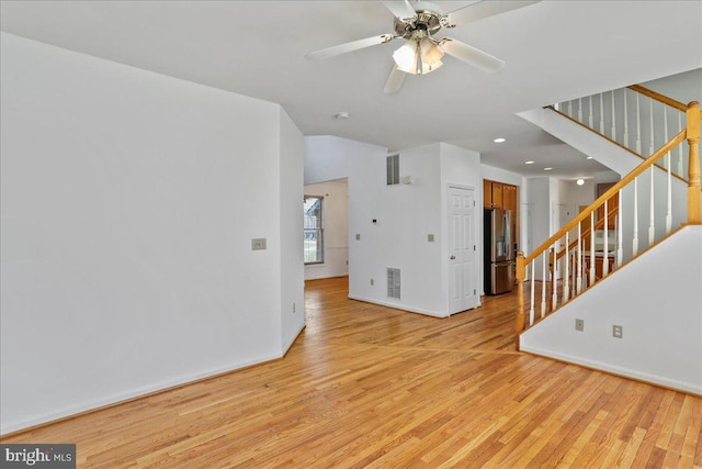 461 Apple Cross Rd, Harpers Ferry, WV 25425 - empty room featuring visible vents, baseboards, light wood-style flooring, stairs, and ceiling fan