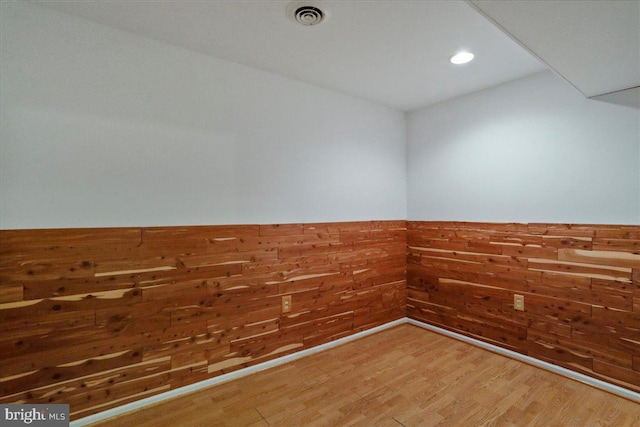 461 Apple Cross Rd, Harpers Ferry, WV 25425 - empty room featuring a wainscoted wall, visible vents, recessed lighting, wood finished floors, and wooden walls