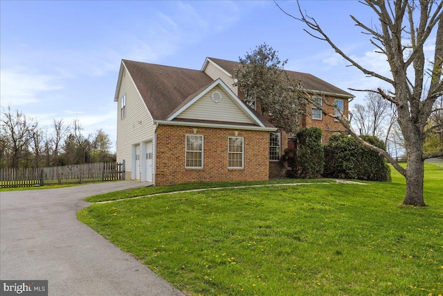 461 Apple Cross Rd, Harpers Ferry, WV 25425 - view of front of house featuring aphalt driveway, an attached garage, fence, a front yard, and brick siding