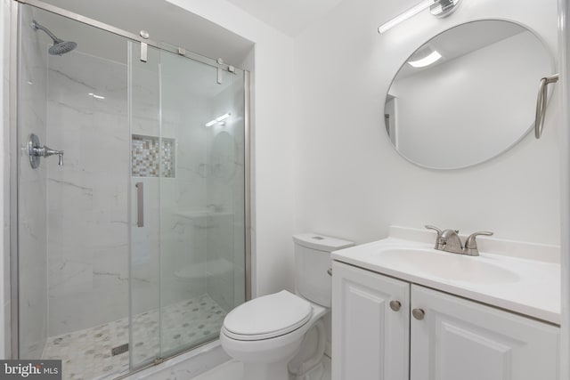 bathroom with toilet, a marble finish shower, and vanity
