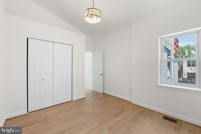 unfurnished bedroom featuring a closet, baseboards, visible vents, and light wood-type flooring