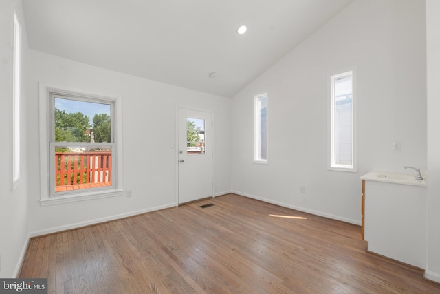 foyer featuring visible vents, baseboards, light wood-type flooring, recessed lighting, and vaulted ceiling
