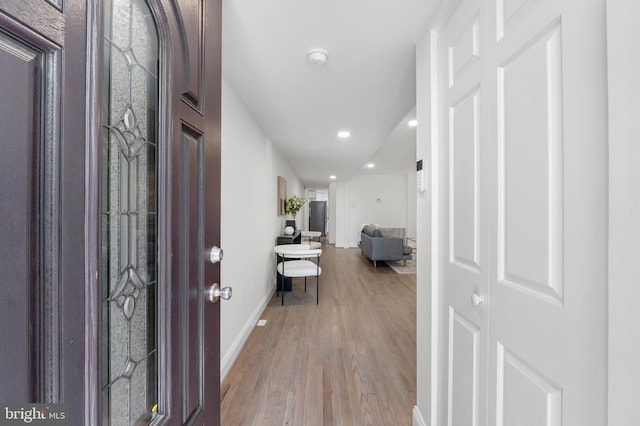 foyer entrance featuring recessed lighting, baseboards, and wood finished floors
