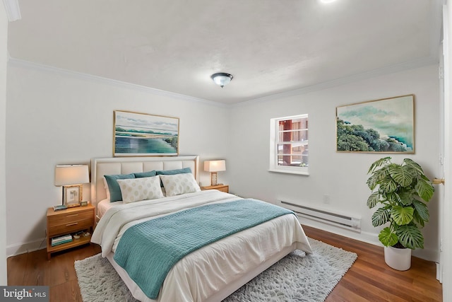 bedroom featuring baseboards, a baseboard heating unit, ornamental molding, and wood finished floors