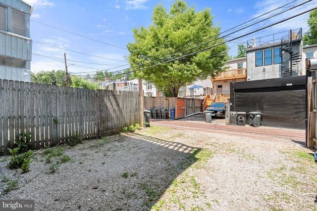 view of yard with a fenced backyard and a wooden deck