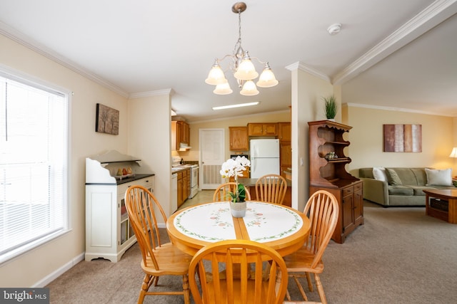 dining space with a chandelier, ornamental molding, a wealth of natural light, and light colored carpet