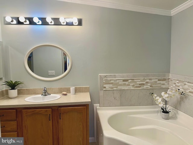 bathroom featuring ornamental molding, a garden tub, and vanity