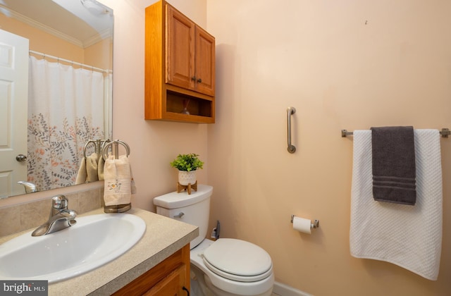 full bath with ornamental molding, vanity, and toilet