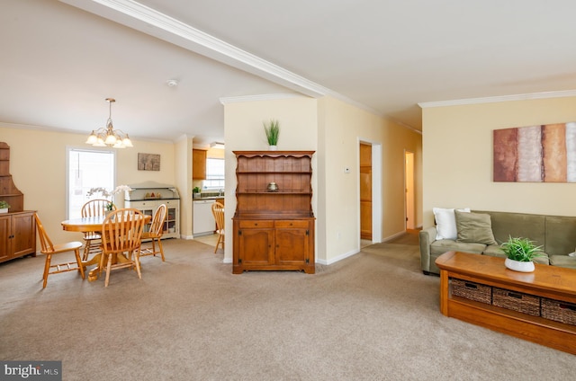 living room with light carpet, ornamental molding, a chandelier, and baseboards