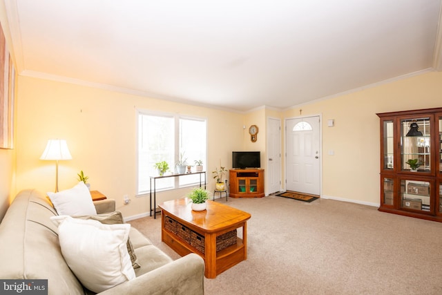 living room with crown molding, baseboards, and light colored carpet