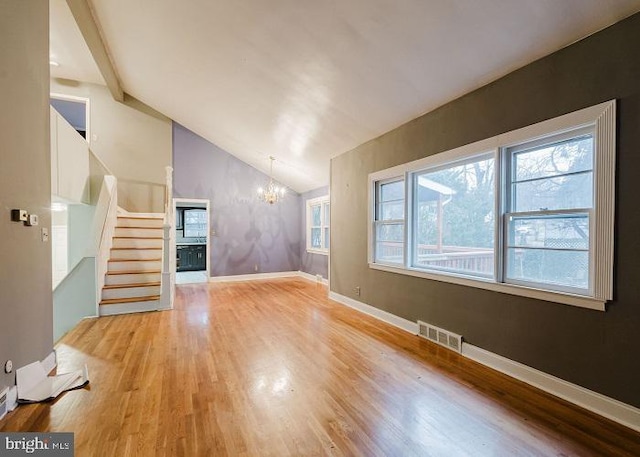 unfurnished living room featuring light wood finished floors, visible vents, stairs, vaulted ceiling, and a chandelier