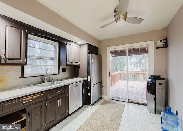 kitchen with plenty of natural light, stainless steel appliances, a sink, and light countertops