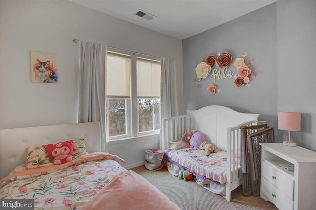 bedroom featuring light colored carpet, visible vents, and baseboards