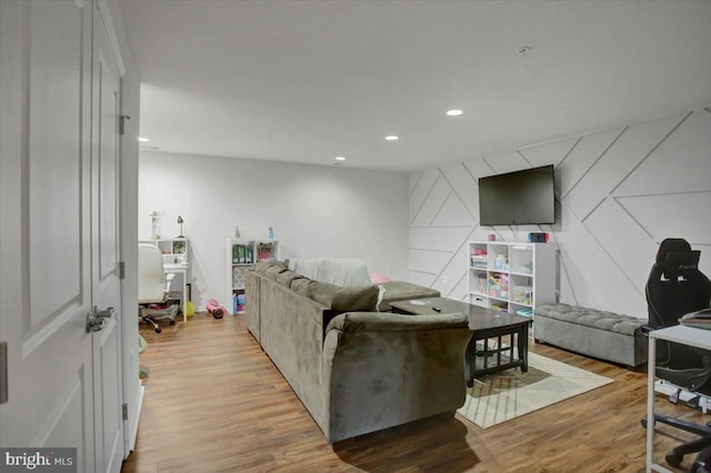 living area with wood finished floors and recessed lighting