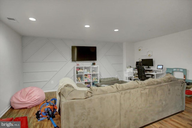 living room with baseboards, wood finished floors, visible vents, and recessed lighting