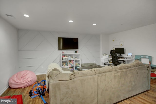 living area featuring recessed lighting, visible vents, and wood finished floors