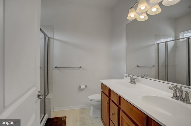 full bath with a stall shower, a sink, toilet, and double vanity